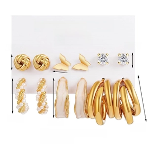 6-piece gold earring set with pearls, crystals, and butterfly motifs in a geometric style