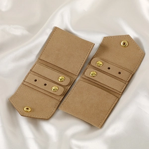 Detail of camel microfiber jewelry roll with gold snap button and stud earring holes