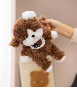 Close-up of soft plush puppy toy with lace floral bib and white ruffle hat accessory