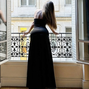 Slim fit strapless black maxi dress with elegant back view on a European balcony