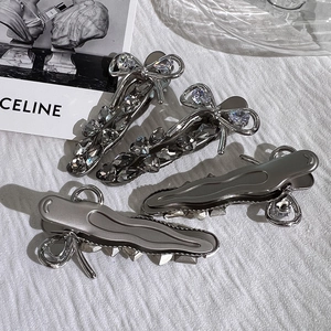 Silver bow hair clips set with sparkling crystals and minimalist wavy metal barrettes