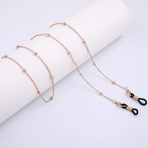 Detail of rose gold beaded eyewear chain with lobster clasps and non-slip rubber loops