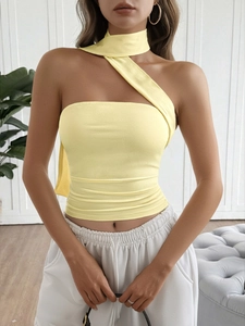 Detail of yellow one-shoulder halter top with ruched texture and slim fit design