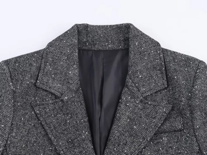 Detail of classic black and white herringbone tweed blazer collar and fabric texture