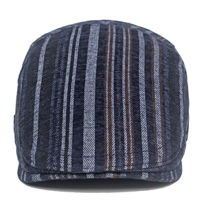 Detail shot of striped texture on dark blue cotton flat cap with vintage woven patterns