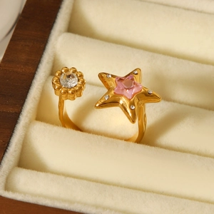 Close-up of golden star-shaped open ring with pink zircon gemstone in a jewelry box