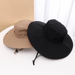 Detail view of khaki and black wide-brim sun hats with adjustable wind ropes and snaps