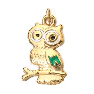 Close-up of golden owl pendant with green enamel wings for DIY jewelry making