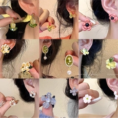 Detailed collection of pearl and zircon bow earrings featuring colorful enamel flowers
