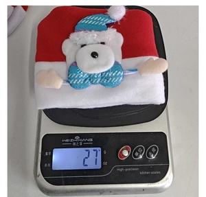 Detailed view of lightweight Christmas hat weighing 27g with a plush polar bear figure