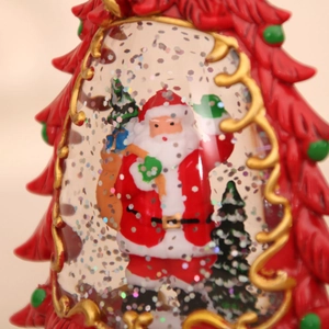 Close-up of red Christmas tree lantern with Santa Claus and sparkling glitter flakes