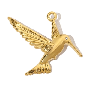 Detailed view of luxury gold hummingbird pendant with sparkling zircon eye detail