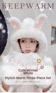 Detail of plush white winter hood scarf and glove set with cute pink paw and rabbit ears