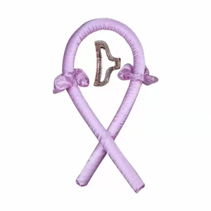 Detail view of pink satin heatless hair curler set with matching scrunchies and clear claw clip