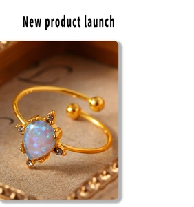 Macro shot of 18K gold-plated adjustable ring with teardrop opal and small diamonds