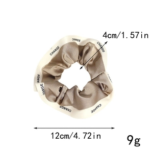 Detailed dimensions of champagne gold scrunchie with CHANGE letter print on edge