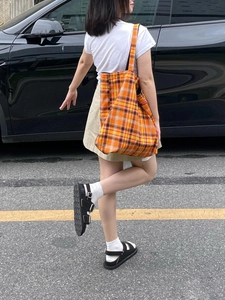 Fashionable orange plaid canvas tote bag for women showing a large capacity shoulder design