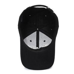 Internal view of black cotton baseball cap showing sweatband and adjustable metal buckle