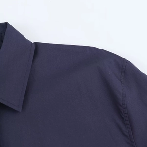 Detailed view of the dark blue poplin shirt collar and shoulder tailoring with clean stitching