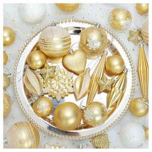 Close-up of luxury gold Christmas ornaments with various textures on a vintage tray