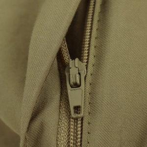 Close-up of khaki casual shorts featuring a durable zipper fly and premium twill fabric texture