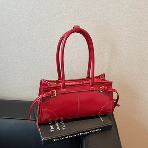 Classic red shoulder bag with top handles and gold buckle details in a retro style