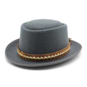 Detail of grey wool pork pie hat featuring a brown braided band and reinforced brim edge