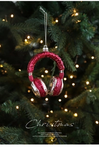 Macro shot of red glitter headphone ornament hanging on a Christmas tree branch