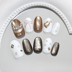 Cat eye pearl press-on nails with 3D bow and star patterns in champagne gold finish