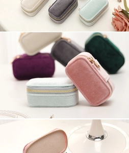 Macro detail of compact velvet jewelry organizer box with smooth zipper and soft texture