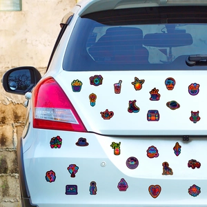 Neon style stickers set with various cartoon icons on a silver car trunk surface