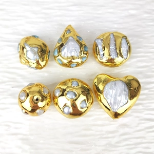 Detail of assorted gold plated natural freshwater pearls in irregular DIY shapes