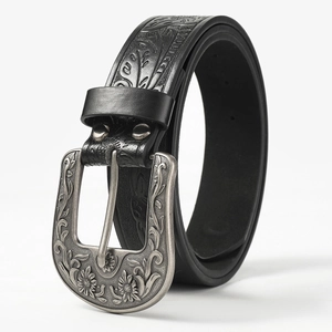 Western style black leather belt with vintage floral engraved silver buckle on white background