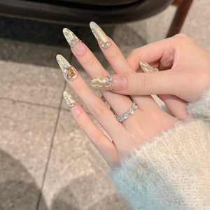 Detailed luxury long almond cat eye press-on nails with champagne gold foil and crystals