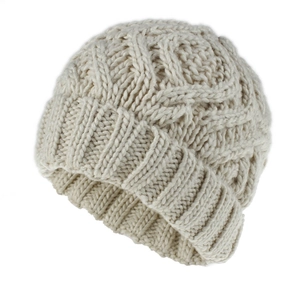 Detail of chunky knit winter hat in cream beige showing thick diamond knit pattern