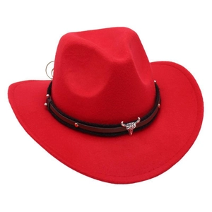 Detail of red cowboy felt hat featuring silver bull head ornament and studded band