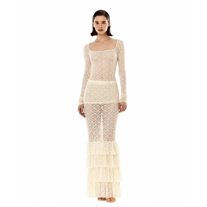 Close-up of beige lace fabric showing intricate floral patterns and ruffled hem details