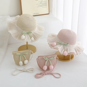 Detail of girl's straw hat set with lace brim, tulip charms, and matching shell crossbody bag