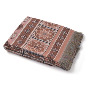 Detailed view of woven geometric floral patterns and colorful tassels on camping blanket