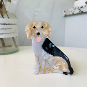 Detail of dachshund hair claw clip made of marble texture acetate with golden outlines