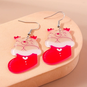 Detail view of cute Christmas stocking and bear acrylic earrings on a foam display