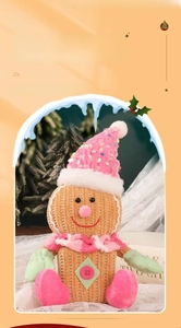 Detail of Christmas gingerbread man plush lamp with pink sequined hat and scarf