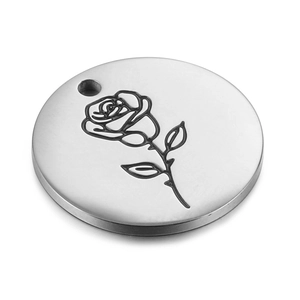 Polished stainless steel round pendant with engraved rose pattern on a white background