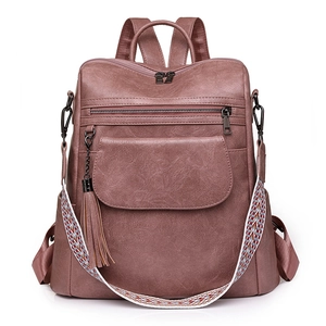 Sac à dos vintage rose poudré avec bandoulière tissée colorée et pendentif à franges