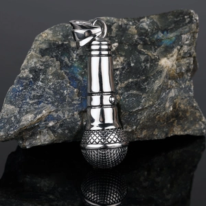 Macro shot of silver microphone pendant showing mesh texture and polished steel finish