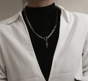 Detailed view of silver cross necklace with mixed chain links and OT toggle clasp closure