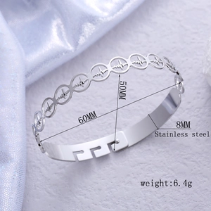 Silver stainless steel oval clasp bangle with minimalist cutout heartbeat ECG design