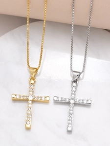 Detailed close-up of gold and silver cross necklaces with micro-pave cubic zirconia