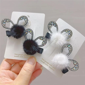 Detail of plush faux mink bow hair clips with rhinestone rabbit ears for young girls