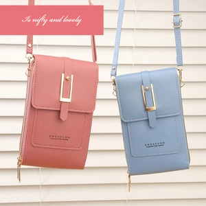 Detail of pink and blue touchscreen phone bags featuring lychee grain texture and metal buckles